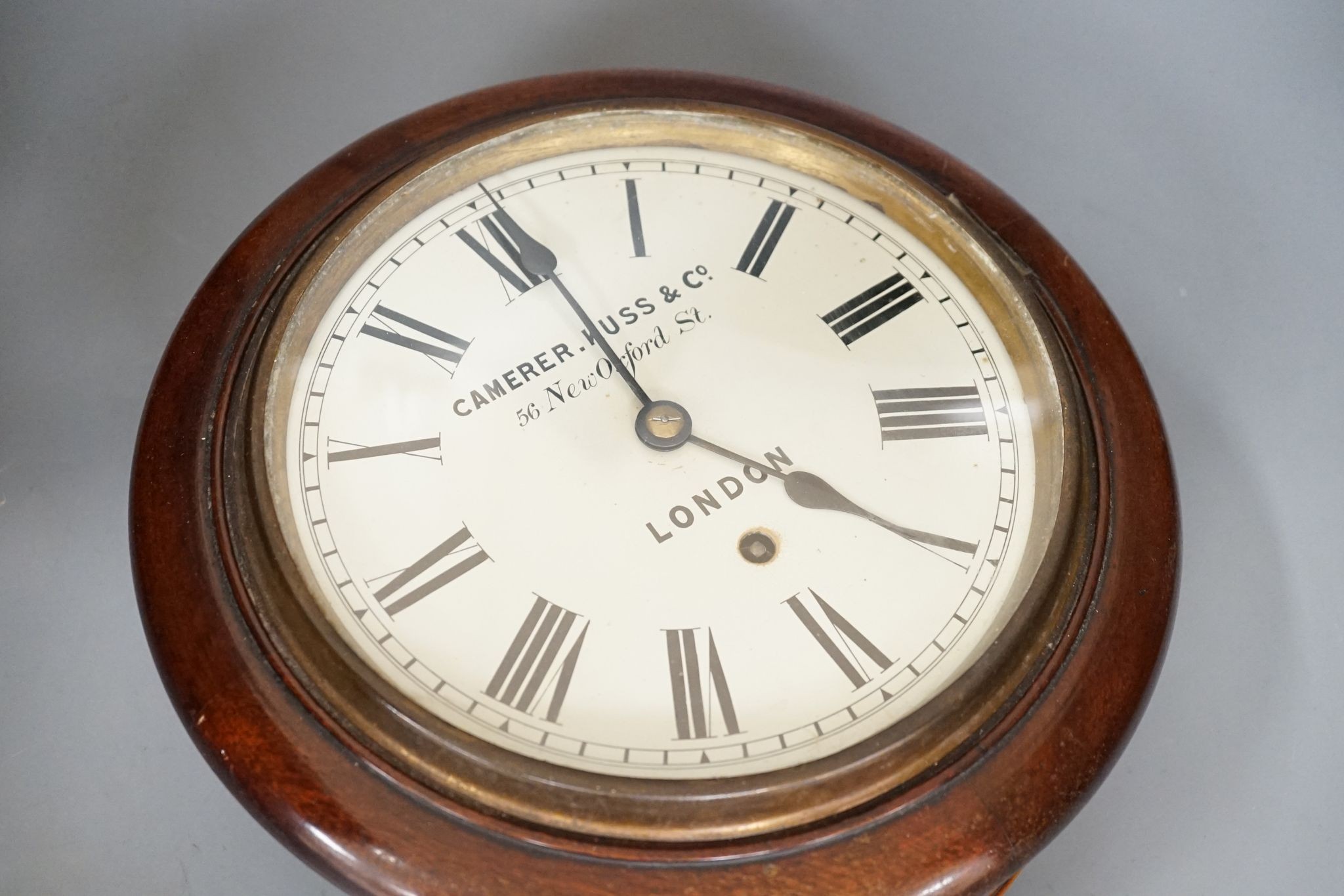 A Camera Kuss & Co. mahogany dial clock, 30 cms diameter.
